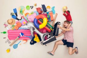 Germany, Artificial scene with man opening baggage full of beach toys